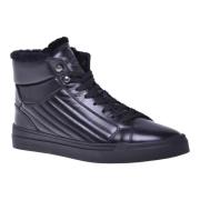 Trainers in black quilted leather and leather